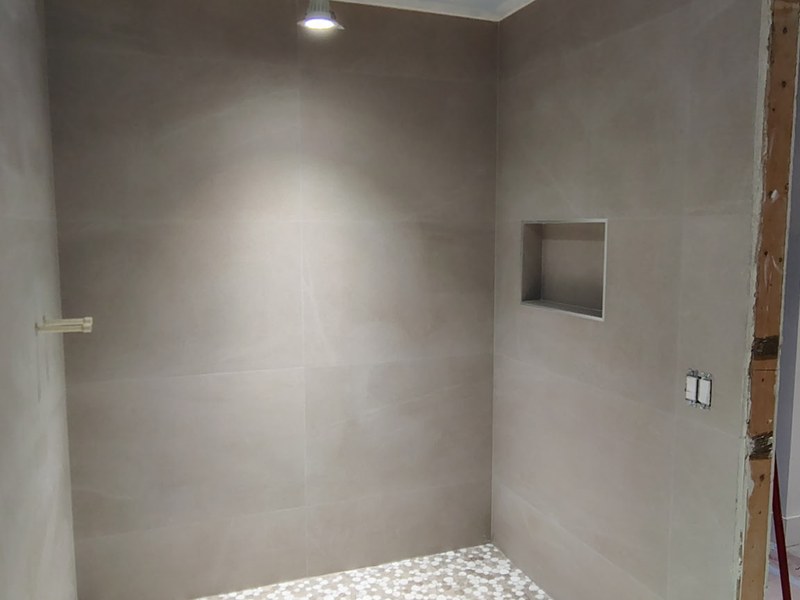 Finished shower with pebble floor and linear drain
